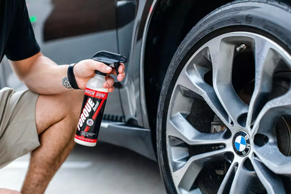 Over-spray Removal: Skilled technician removing overspray from a car's surface